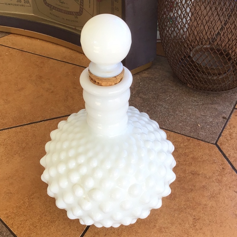 While milk glass perfume bottle with cork stopper
